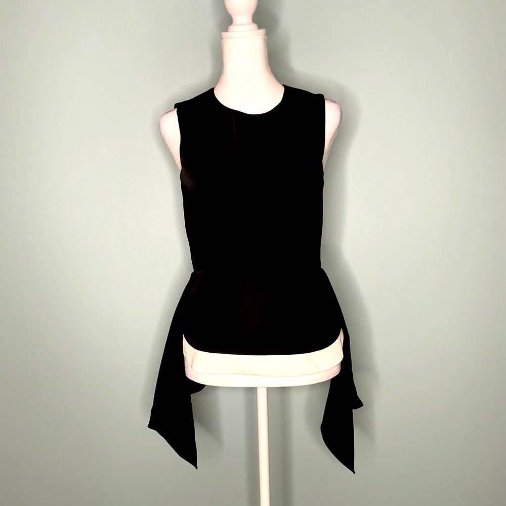 BCBGMaxazria black peplum sleeveless top with back zip.  Size XS